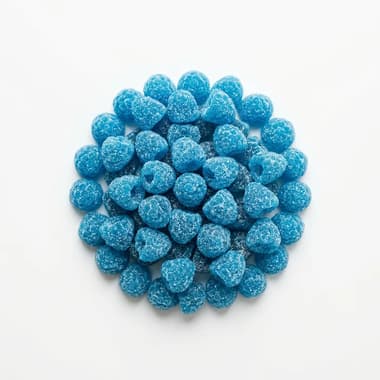 A round pile of bright blue sugar-coated raspberry sweets on a plain white background