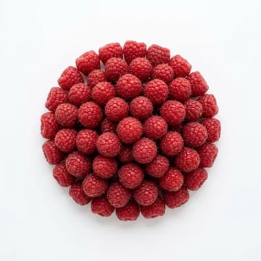 A round pile of fresh red raspberries on a plain white background