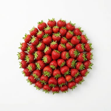 A round pile of whole red strawberries with green tops on a plain white background
